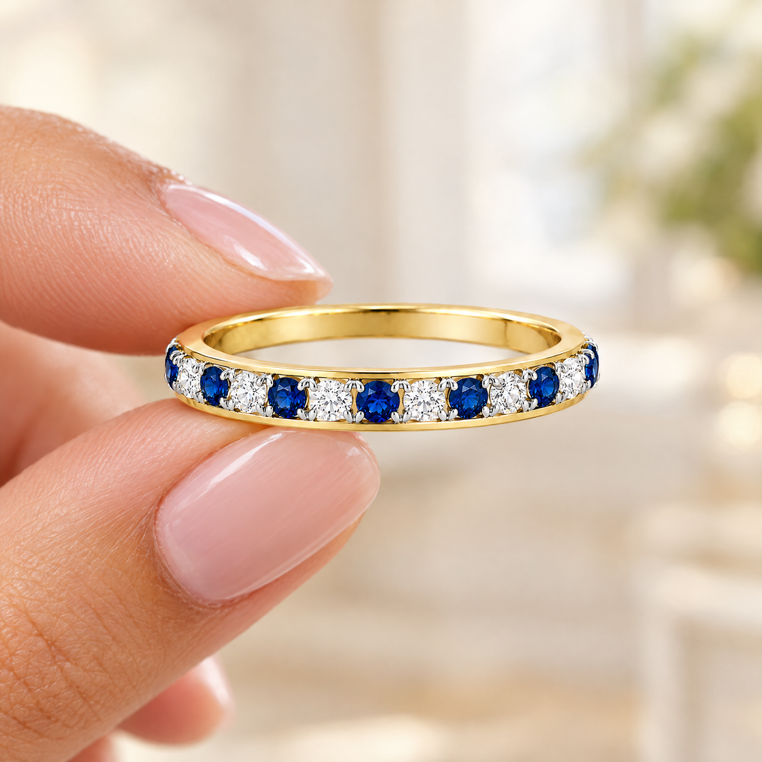 Blue Stone Eternity Band held in fingertips