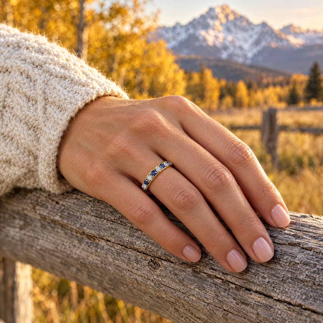 Blue Stone Eternity Band worn on a hand, cedar rail and golden aspens, Ideaure photo