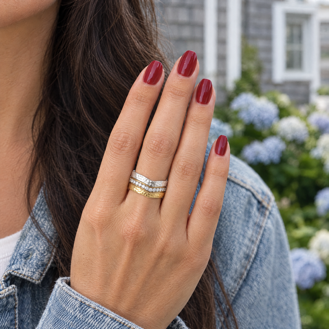 Ripple Hammered Wave Ring worn with a faded denim jacket over white, a grey-shingled beach house with hydrangeas