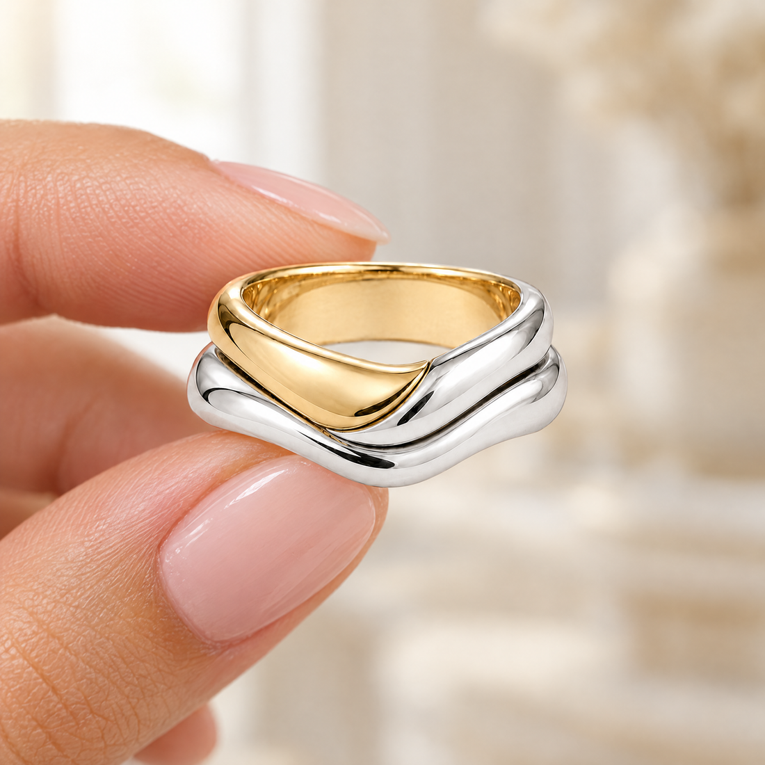 Polished Wave Stack Ring held in fingertips