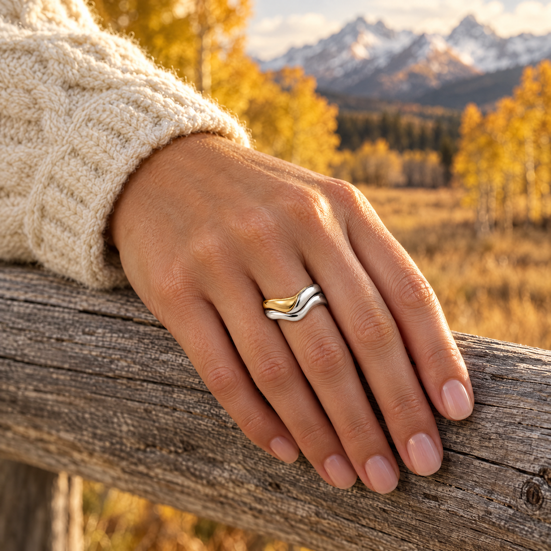 Polished Wave Stack Ring worn on a hand, cedar rail and golden aspens, Ideaure photo